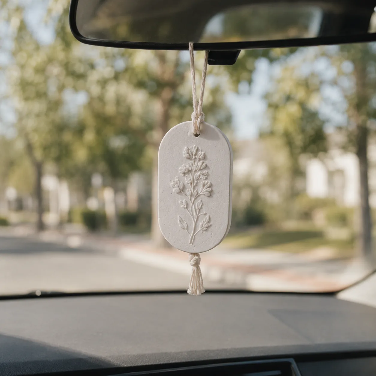 Aroma stone tag hanging from a car mirror